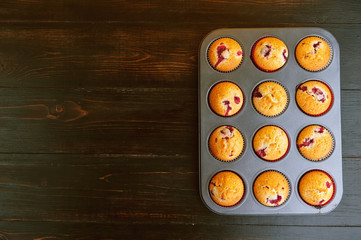 Muffin in a baking dish on a wooden background