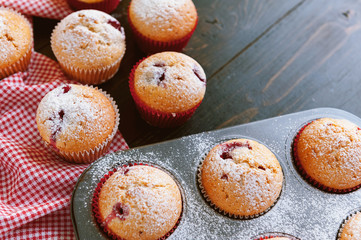 Muffin in a baking dish on a wooden background