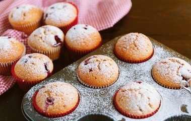 Muffin in a baking dish on a wooden background