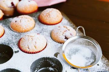 Muffin in a baking dish on a wooden background