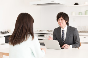 asian businessman talking in kitchen