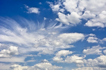 Clouds against a blue sky in a sunny day.
Clouds lit by the rays of the sun.