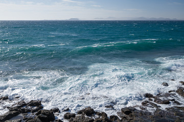 Fototapeta na wymiar The splash of the waves on the rocky coast of the Atlantic Ocean