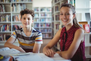 happy schoolboy sitting with his classmate