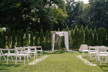 Beautiful wedding archway. Arch decorated with biege cloth and flowers