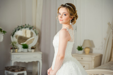 Beautiful bride before wedding ceremony in appartament