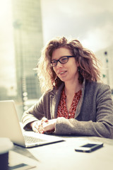 Businesswoman Sitting Outdoors, Working On Her Computer