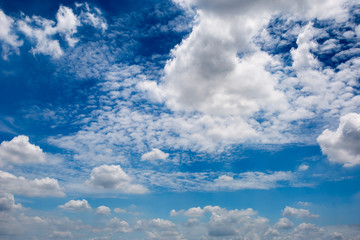 Blue sky background with white clouds, rain clouds and sunlight with lens flare on rainy season or spring day.