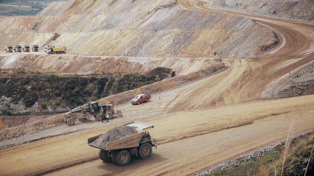 Mining dump truck transporting mineral on the road of an open pit mine. 4k