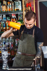 The bartender making cocktail
