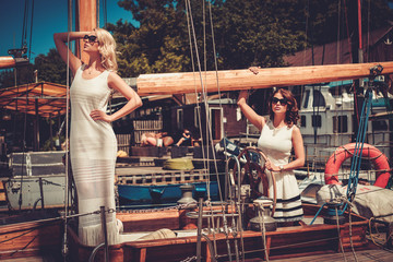Stylish wealthy women on a luxury yacht