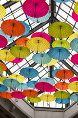Fototapeta na wymiar Colorful umbrellas in the sky, street decoration
