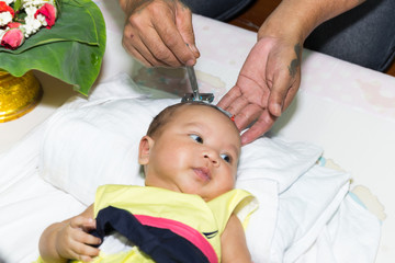 Shaving hair of new born infant when Three month aged tradition of thai people