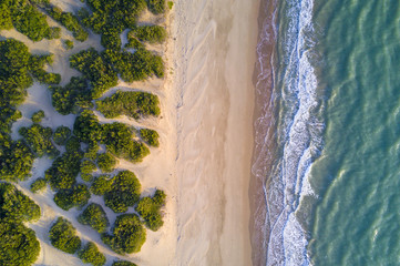 Stunning aerial view of an Italian wild beach during the sunset. - obrazy, fototapety, plakaty