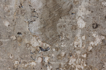 Rough cement surface embedded with small pebbles and irregular textures, ideal for industrial...