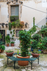 Fototapeta na wymiar House courtyard on the Ortygia isle - old town of Syracuse on Sicily island, Italy