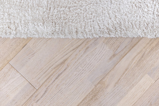 Parquete floor with beige soft carpet