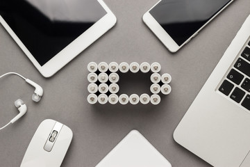 conceptual image of battery charge level pictogram made of rechargeable batteries with some mobile...