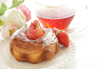 strawberry danish pastry with tea for breakfast image