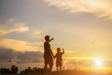 Fototapeta premium Father took the baby learn to walk at sunset.
