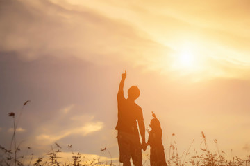 Fototapeta premium Father took the baby learn to walk at sunset.