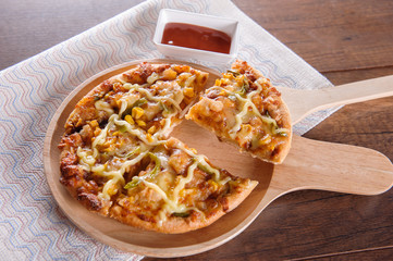 Delicious tasty pizza with on wooden table