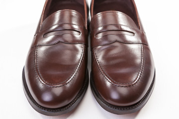 Footwear Concepts. Closeup of Pair of Stylish Brown Penny Loafer Shoes On White. Placed Together With Each Other