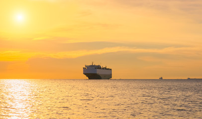 Cargo container ship at sunset