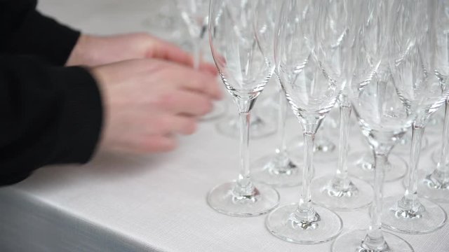 Catering preparation before the wedding, putting down flutes for  the welcome drink, 4K