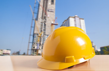 Safety helmet with construction site background
