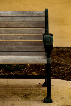 An Empty End Seat of a Wooden Park Bench