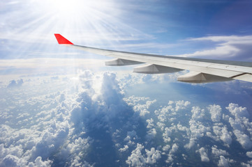 Fototapeta premium aerial view of cloudscape looking through airplane window