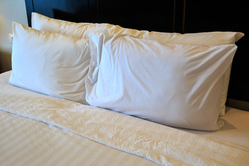 Hotel pillow bed in hotel room.