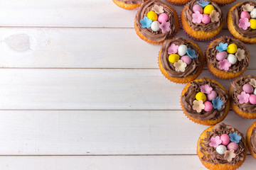 Easter Cup Cakes from Above with Copy Space on White Wooden Table
