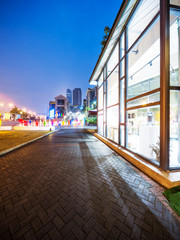 Fototapeta na wymiar empty footpath and modern building with glass wall