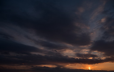 Beautiful sunset sky with dark clouds.