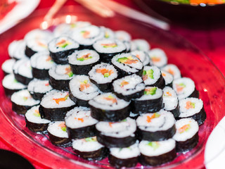 A plate full with sushi rolls.