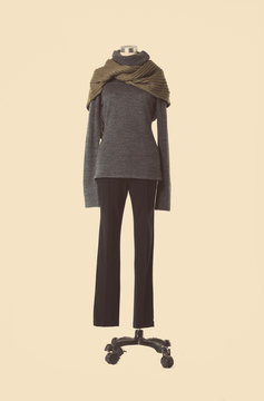 full-length female dress with scarf and trousers isolated on a dummy 

