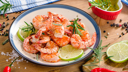 Grilled shrimps on a plate with seasonings. Healthy food