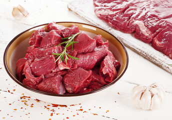 Fresh raw beef on white wooden table
