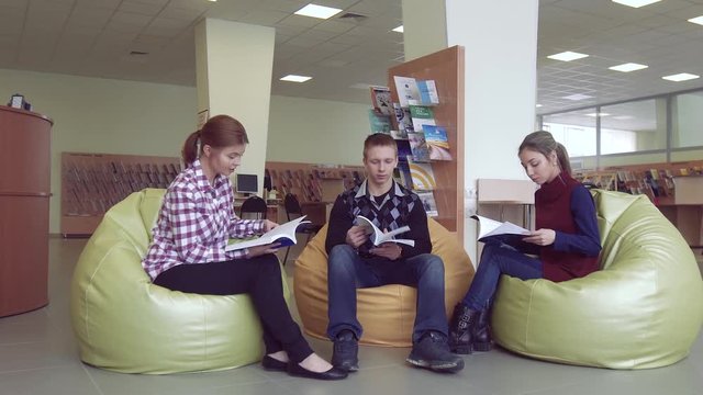 Group of young people sitting in a library