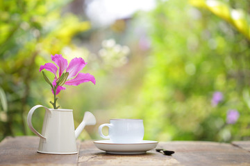 Fototapeta na wymiar coffee with Butterfly Tree flower on wooden table