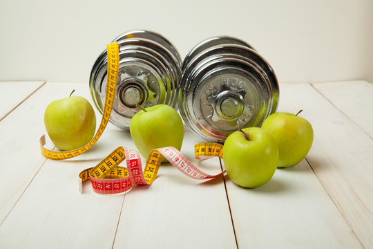 dumbbells and dietary food fresh fruit