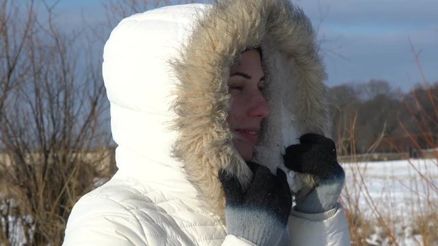 Young beautiful woman having fun on winter time outdoors 