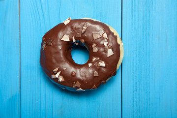 Doughnut on blue wooden table