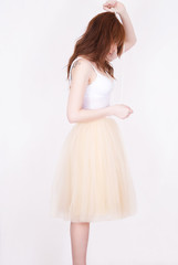 fashion girl in tulle skirt on white background