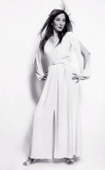 black and white photo. beautiful fashion girl in white long dress