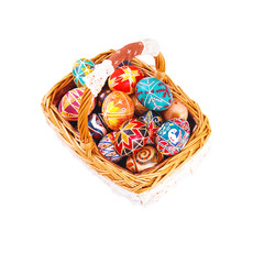 Fototapeta na wymiar Easter eggs in a basket, isolated on a white background.
