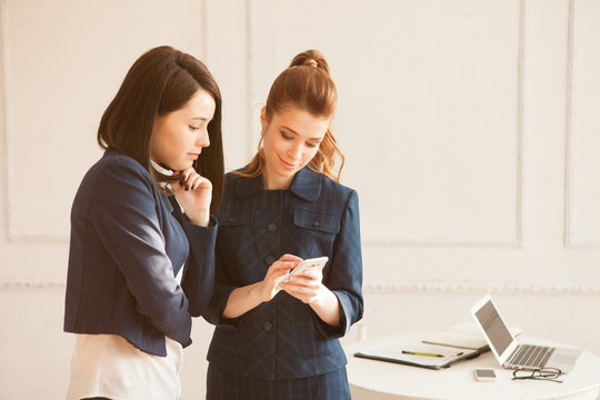 two business woman with smartphone