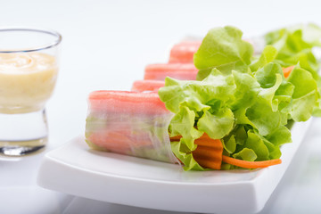 Fresh vegetable salad roll in noodle tube isolated on white background.